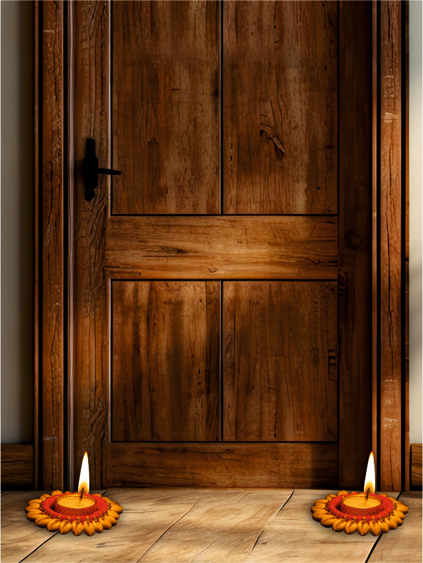 Two lit oil lamps on a wooden floor in front of a wooden door.