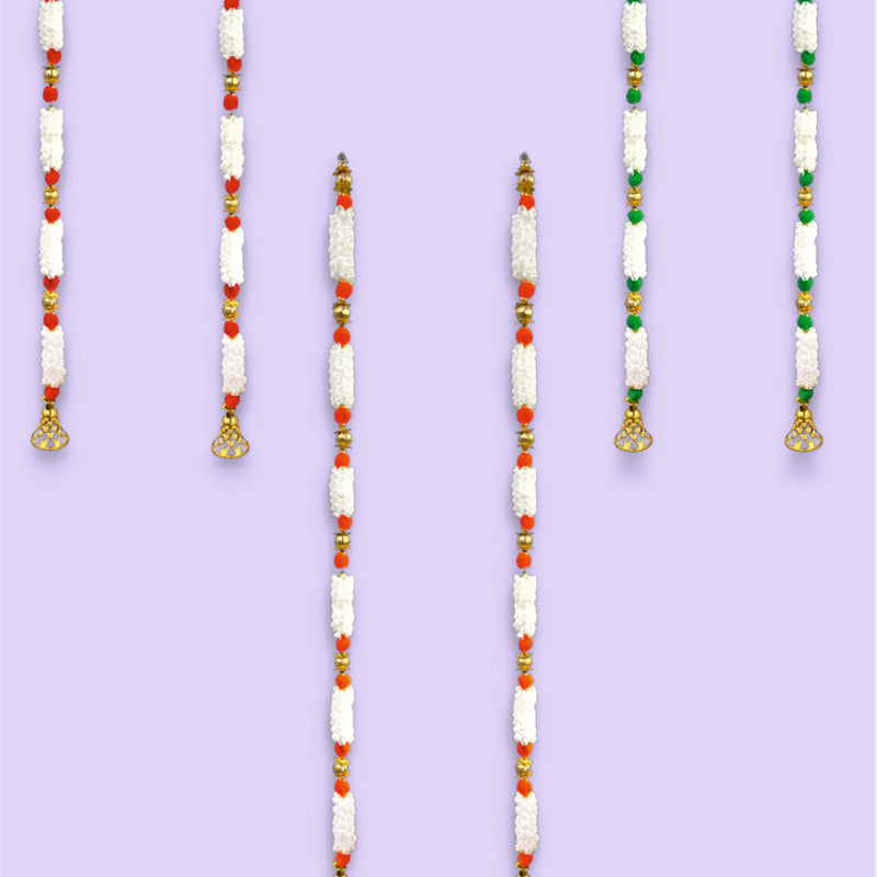 Set of beaded necklaces with red, green, and white beads on a purple background.