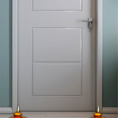 Gray door with two lit candles on a wooden floor