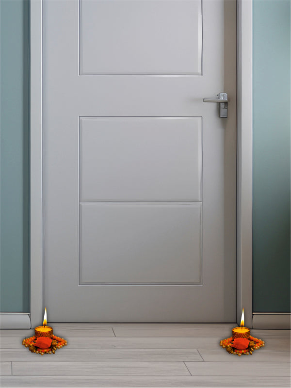 Gray door with two lit candles on a wooden floor