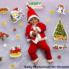 Child in Santa Claus outfit with Christmas-themed decorations on a gray background