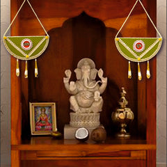 Wooden deity altar with Ganesha statue, framed photo, and decorative items.