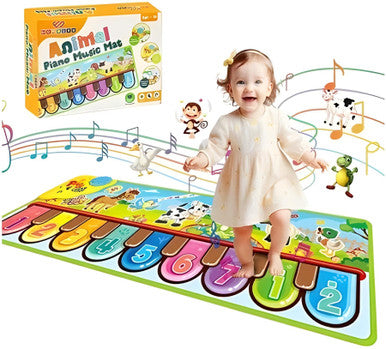 Child playing on a colorful piano mat with animal illustrations and a toy box in the background.