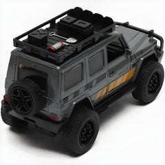 Model of a gray off-road vehicle with roof rack and tools on a white background