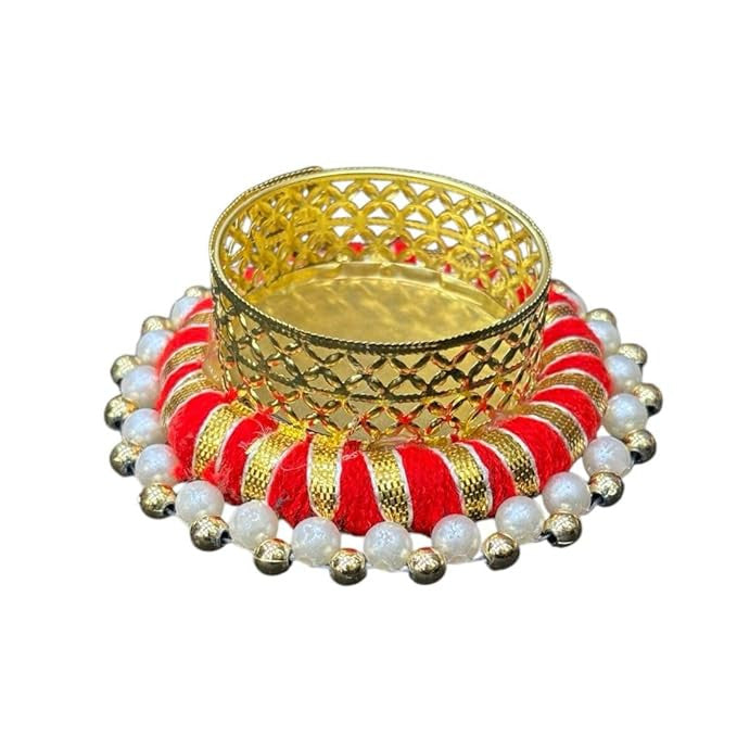 Decorative oil lamp with gold, red, and white elements on a white background
