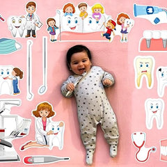 Baby lying on a pink background with dental-themed illustrations