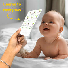 Baby lying on a bed with a person holding up a card with green circles, labeled 'Learns to recognize'.