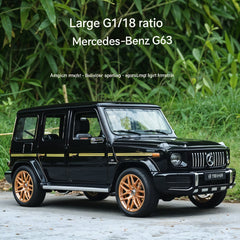 Black Mercedes-Benz G63 with gold rims on a road with greenery in the background