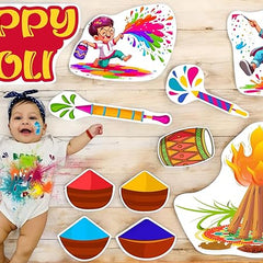 Child with Holi-themed decorations and a baby on a wooden floor
