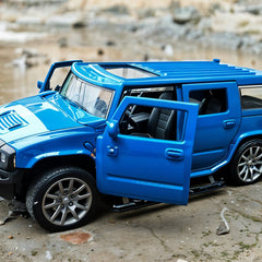Blue toy SUV with open door on a textured surface