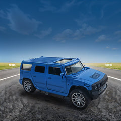 Blue toy SUV on a road with a clear blue sky