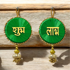 Green earrings with gold accents and text on a wooden surface
