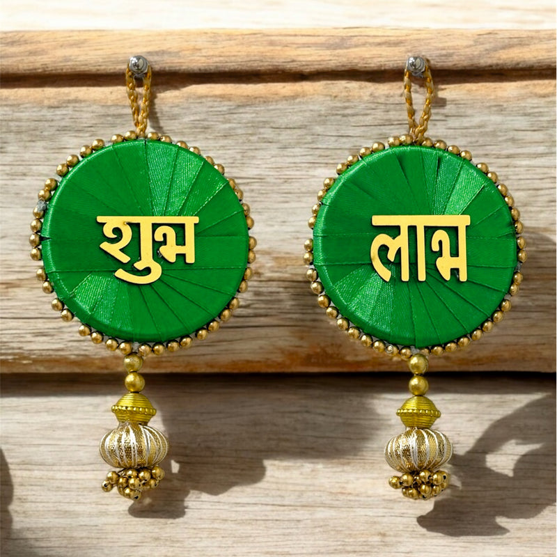 Green earrings with gold accents and text on a wooden surface