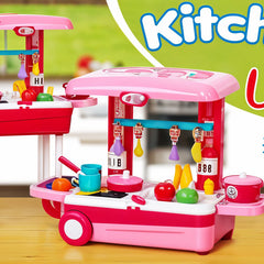 Toy kitchen set with pink and red colors on a wooden surface.