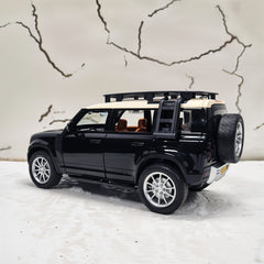 Black SUV model with open doors on a white surface with a map background