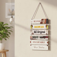 Decorative wall hanging with motivational phrases in a home setting