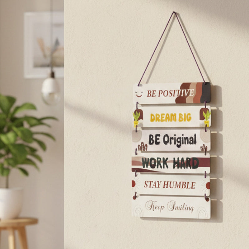 Decorative wall hanging with motivational phrases in a home setting