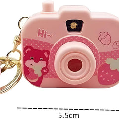 Pink toy camera with keychain and measurements on a white background