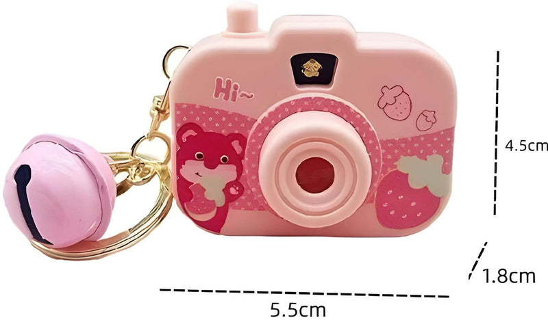 Pink toy camera with keychain and measurements on a white background