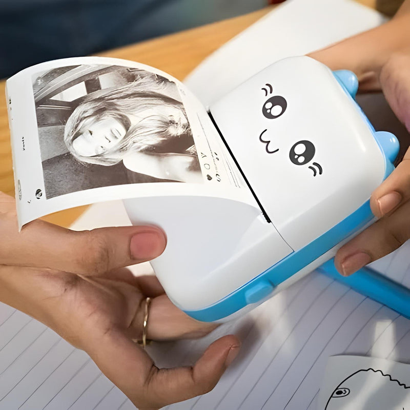 Small printer with cartoon face holding a photo of a woman's face on lined paper.