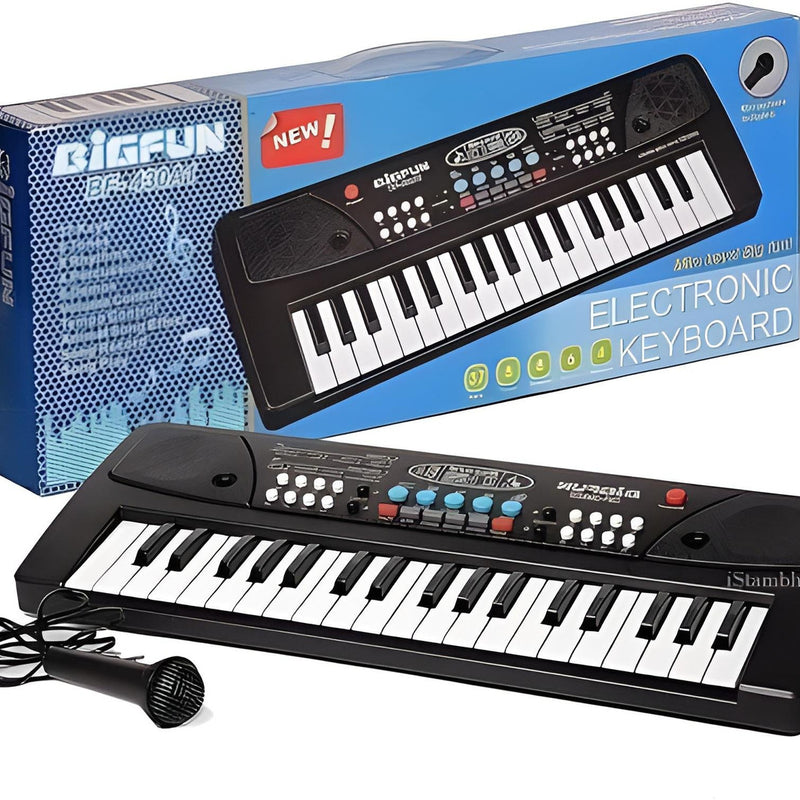 Electronic keyboard with microphone in front of its packaging