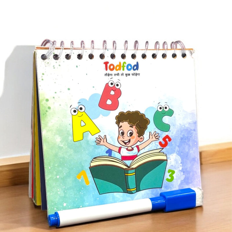 Children's educational book with colorful illustrations and a marker on a wooden surface