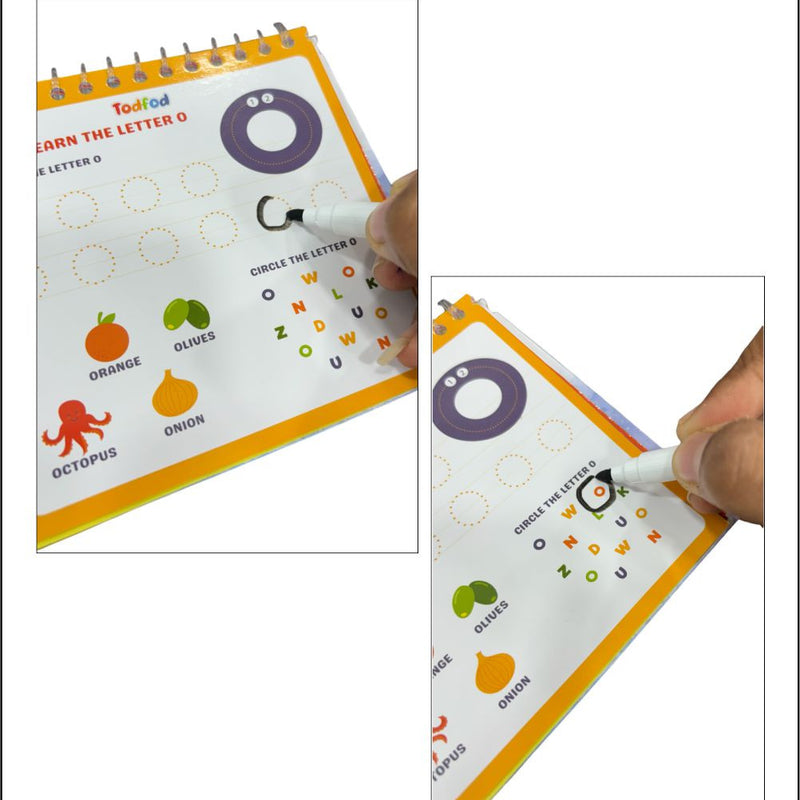 Educational book with letter tracing activity, held by a hand with a pen.