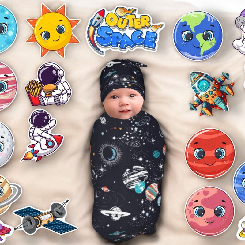 Baby swaddled in a space-themed blanket with surrounding space-themed stickers on a beige background