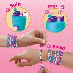 Bracelet-making kit with 'Spin', 'Pop', and 'Swap' steps on a pink background