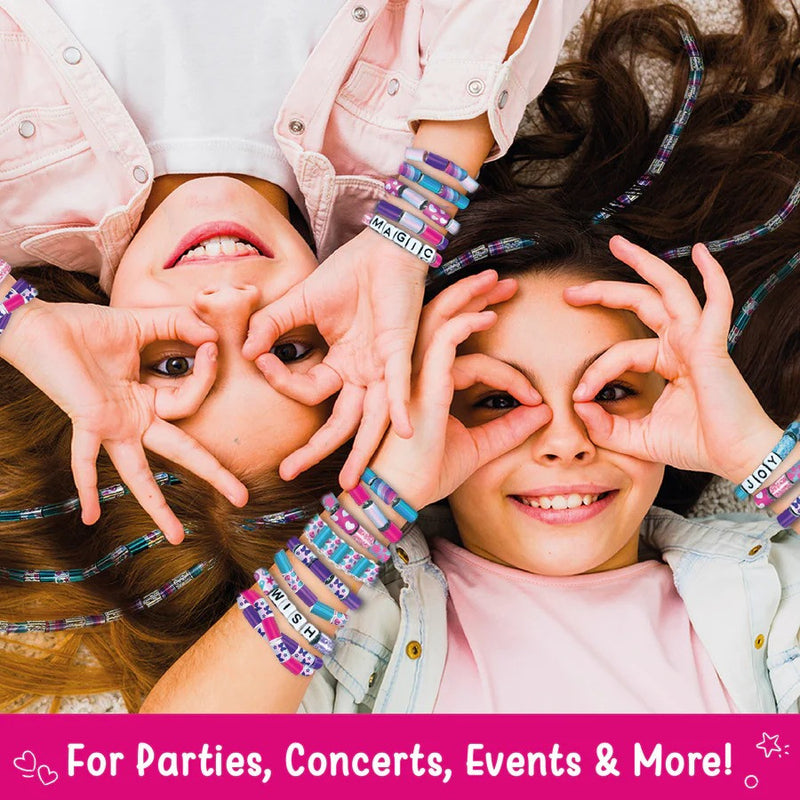 Two children wearing colorful bracelets, making heart shapes with their hands.