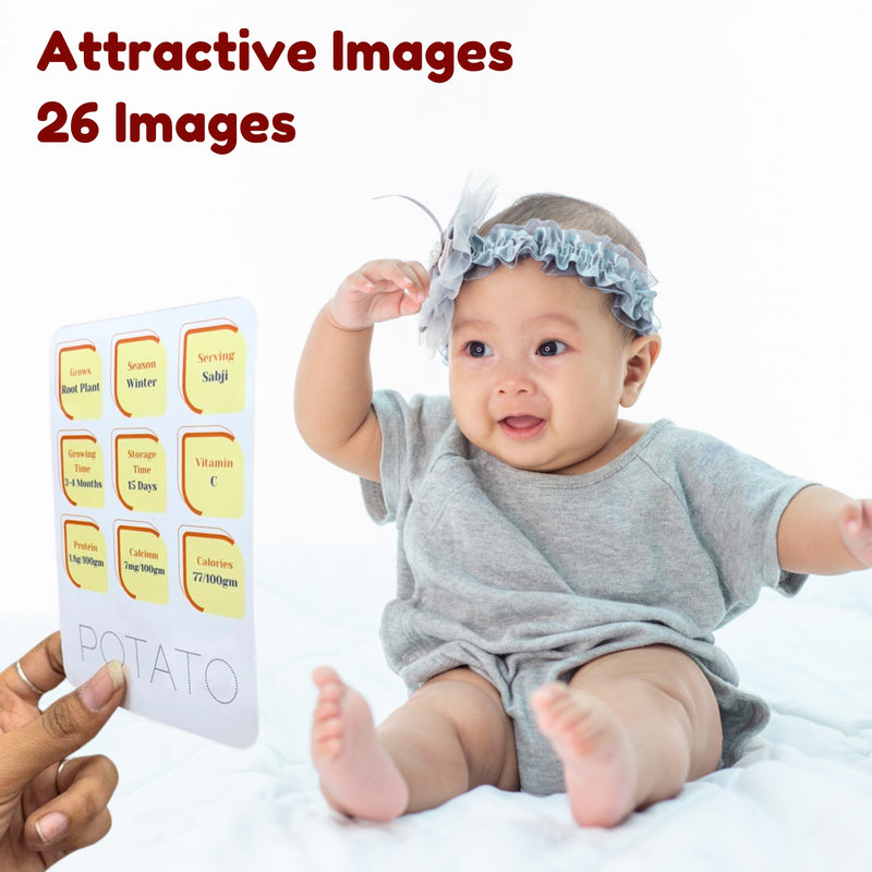 Baby in a gray outfit with a headband, holding a card with nutritional information about potatoes.