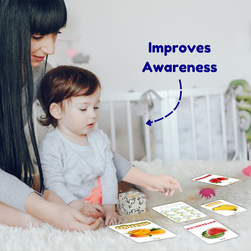 Woman and child playing with educational cards on a carpeted floor.