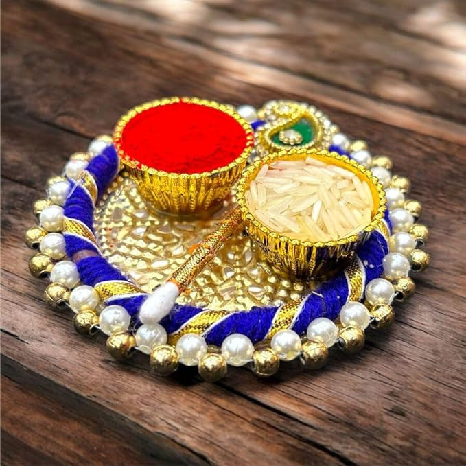Decorative thali with colorful items on a wooden surface