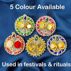 Decorative earrings with colorful stones on a blue fabric background