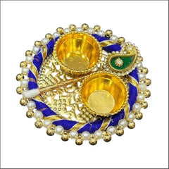 Decorative Diwali lamp with gold and blue design on a white background