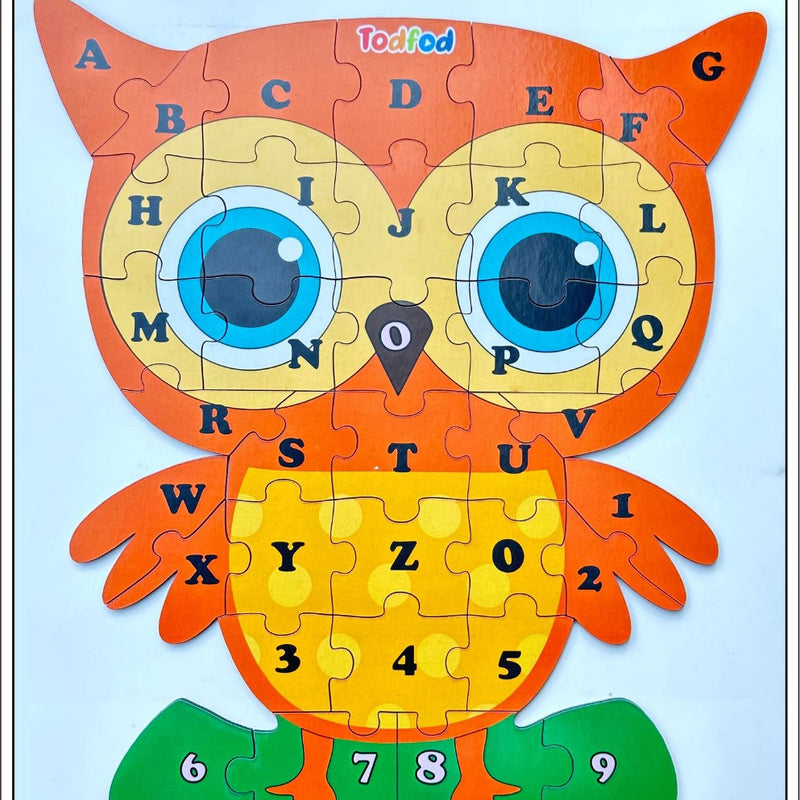 Children's puzzle in the shape of an owl with letters and numbers on a light blue background