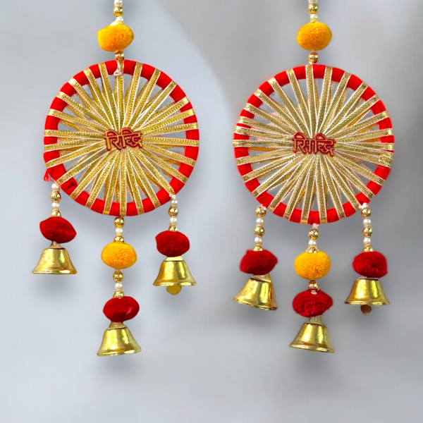 Decorative hanging with red, gold, and yellow elements on a light gray background
