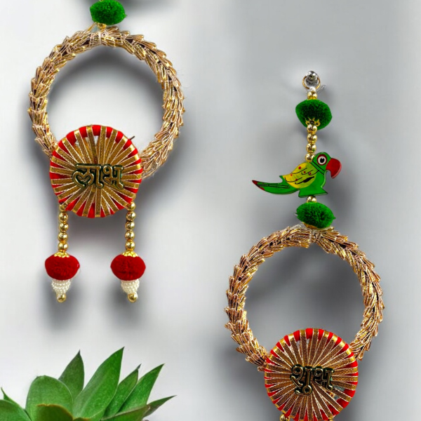 Decorative earrings with gold loops, red and gold circular elements, and green parrot figurines on a light gray background.