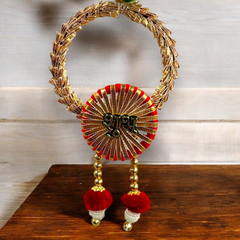 Decorative gold and red item with a central emblem on a wooden surface