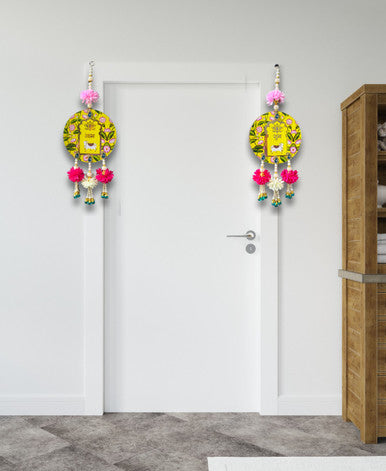 Decorative items hanging on a white door with a wooden cabinet in the background.