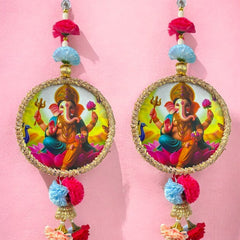 Colorful earrings with a deity design on a pink background