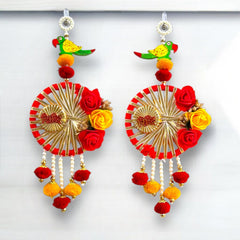 Colorful earrings with floral and decorative elements on a white background