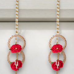 Pair of earrings with red floral elements on a white background