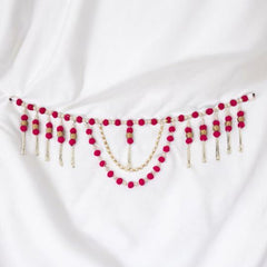 White fabric with red and gold beaded embellishments on a white background