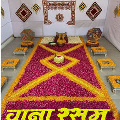 Decorative setup with a large flower arrangement in the shape of a diamond, surrounded by smaller tables and decorations.