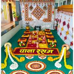 Decorated room with floral arrangements and religious items on a green floor.