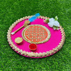 Decorative pink plate with gold rim on a green grass background