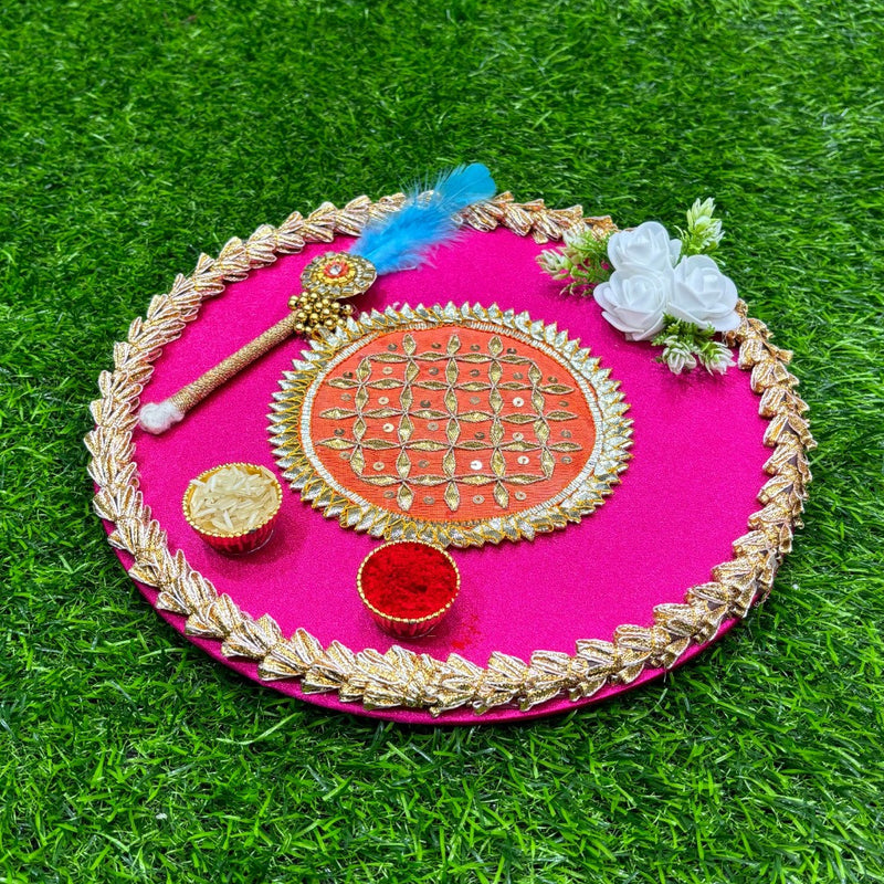 Decorative pink plate with gold rim on a green grass background