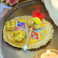 Decorative plate with colorful elements on a tray with candles and flowers