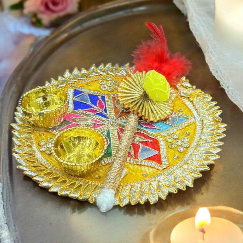 Decorative plate with colorful elements on a tray with candles and flowers